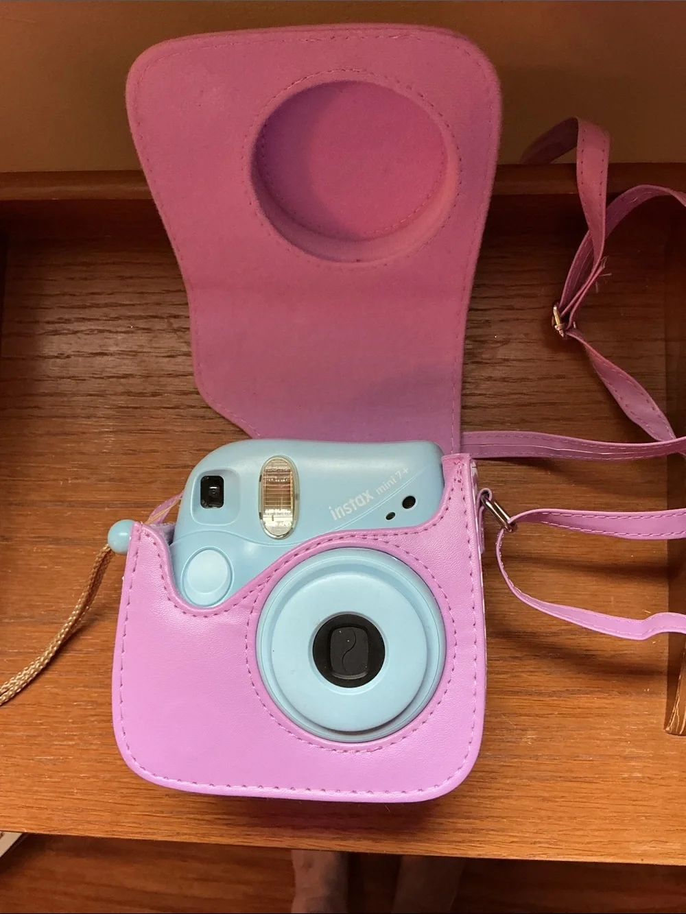 Instax Mini instant camera in light blue with pink carrying case